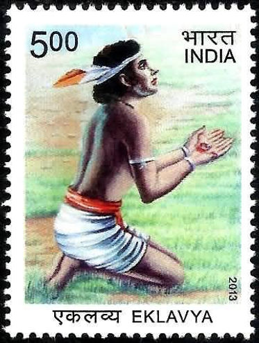 Postage stamp featuring a kneeling Eklavya with a focus on hands in prayer. Text: "500 भारत INDIA 2013 एकलव्य EKLAVYA." Pastoral background.